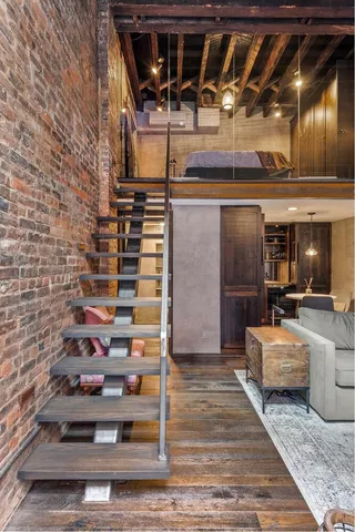 a living room with furniture a fireplace and windows