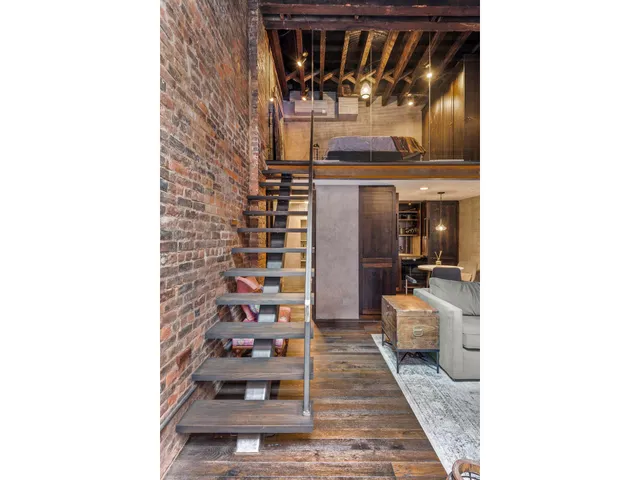 a hallway with a couch and a window