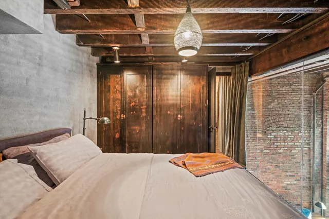 a bedroom with a bed and a chandelier