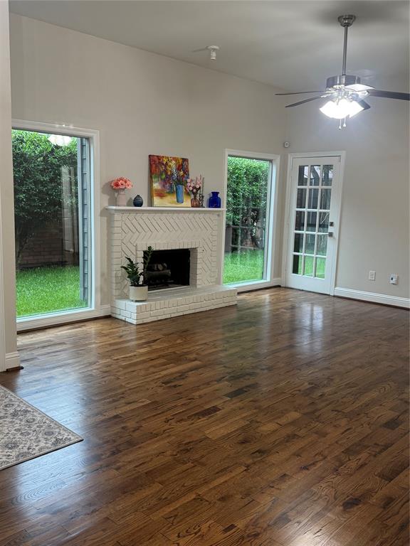 4010 Rive Lane Addison, TX 75001 - Photo 13 of 25 a view of a livingroom with wooden floor a fireplace and window