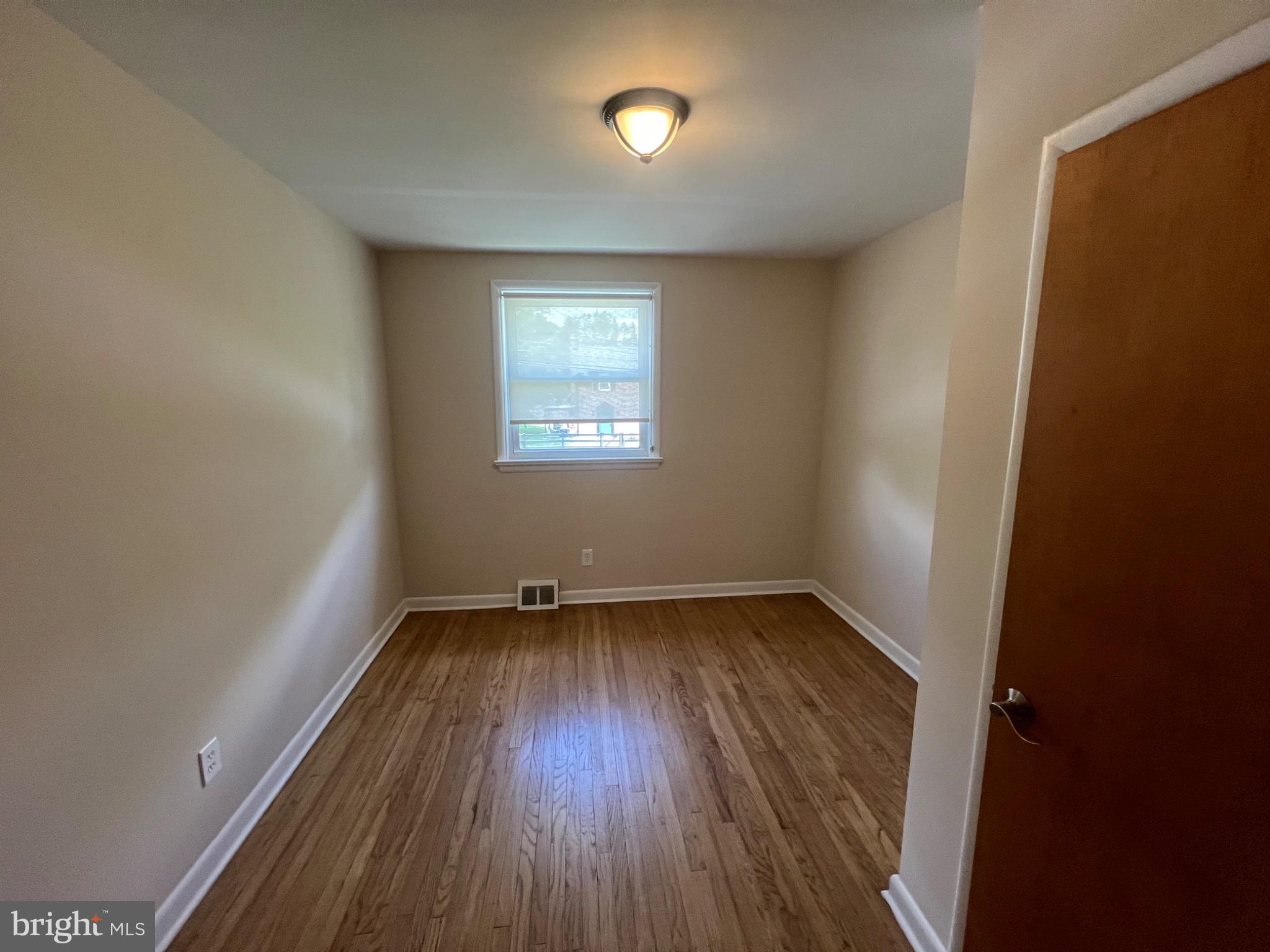 20 Fairview Road Swarthmore, PA 19081 - Photo 21 of 24 an empty room with a hardwood and windows