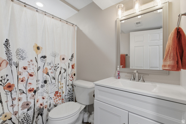 11189 Ohenry Road East Sandy, UT 84070 - Photo 28 of 44 Bathroom featuring a white vanity with integrated sink, brushed nickel faucet, wall-mounted mirror, and recessed lighting