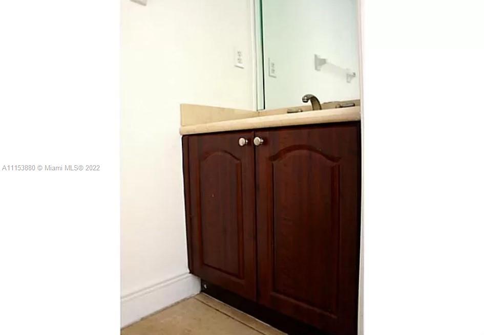 120 South Douglas Road, Unit 306 Miami, FL 33134 - Photo 15 of 17 a kitchen with a sink and a mirror