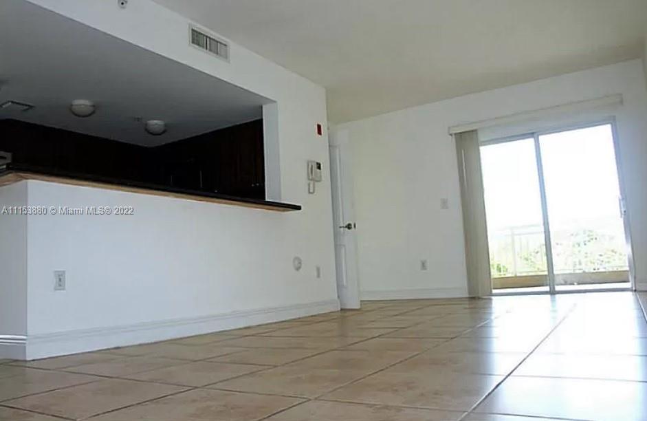 120 South Douglas Road, Unit 306 Miami, FL 33134 - Photo 4 of 17 a view of an empty room with a window