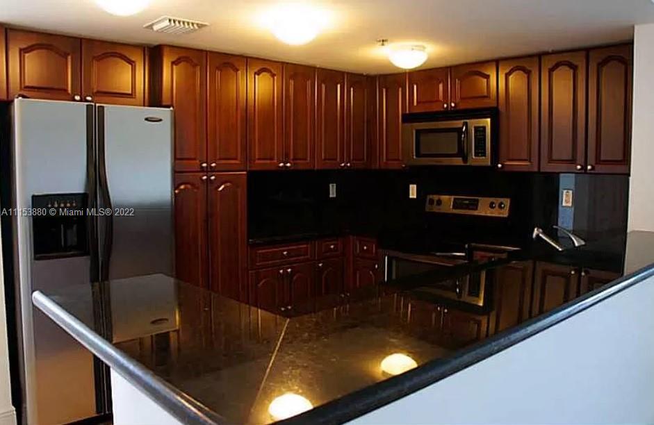 120 South Douglas Road, Unit 306 Miami, FL 33134 - Photo 8 of 17 a kitchen with counter top space