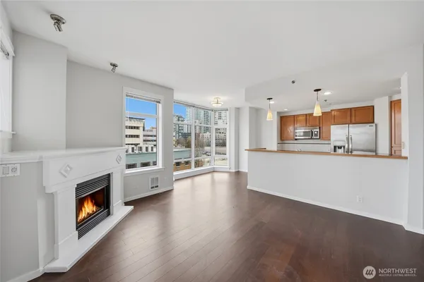 a view of an empty room with a window and fireplace