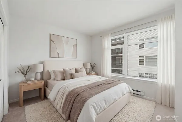 a bedroom with a bed and a window
