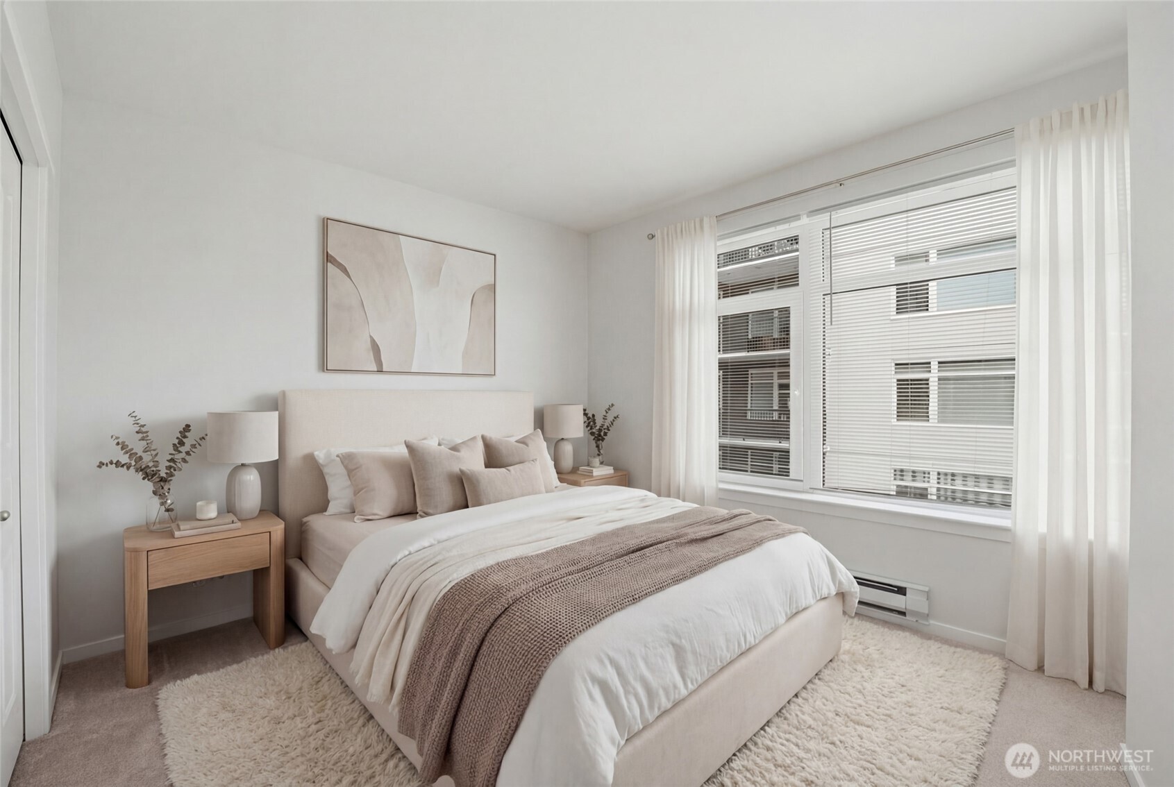 2801 1st Avenue, Unit 504 Seattle, WA 98121 - Photo 12 of 34 a bedroom with a bed and a window