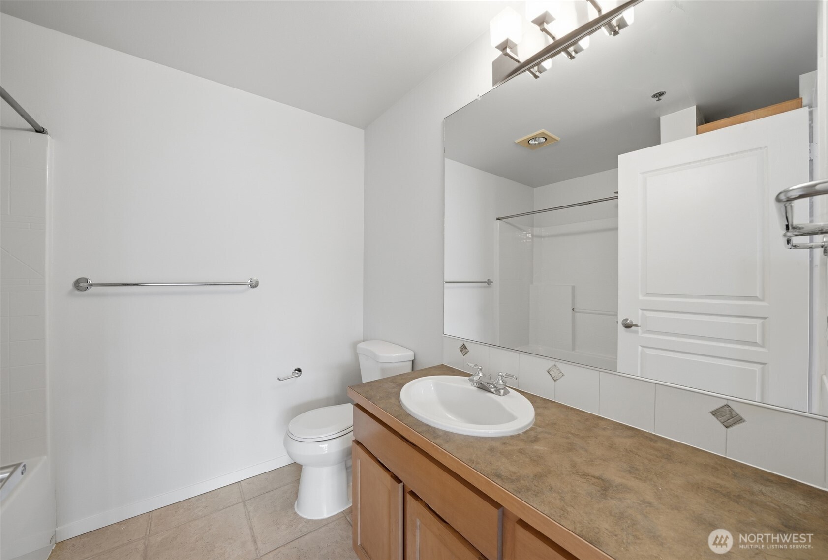 2801 1st Avenue, Unit 504 Seattle, WA 98121 - Photo 16 of 34 a bathroom with a granite countertop sink toilet and shower