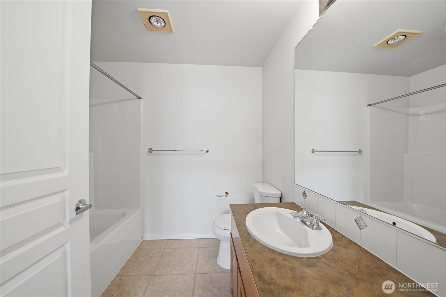 2801 1st Avenue, Unit 504 Seattle, WA 98121 - Photo 17 of 34 a bathroom with a tub sink and mirror