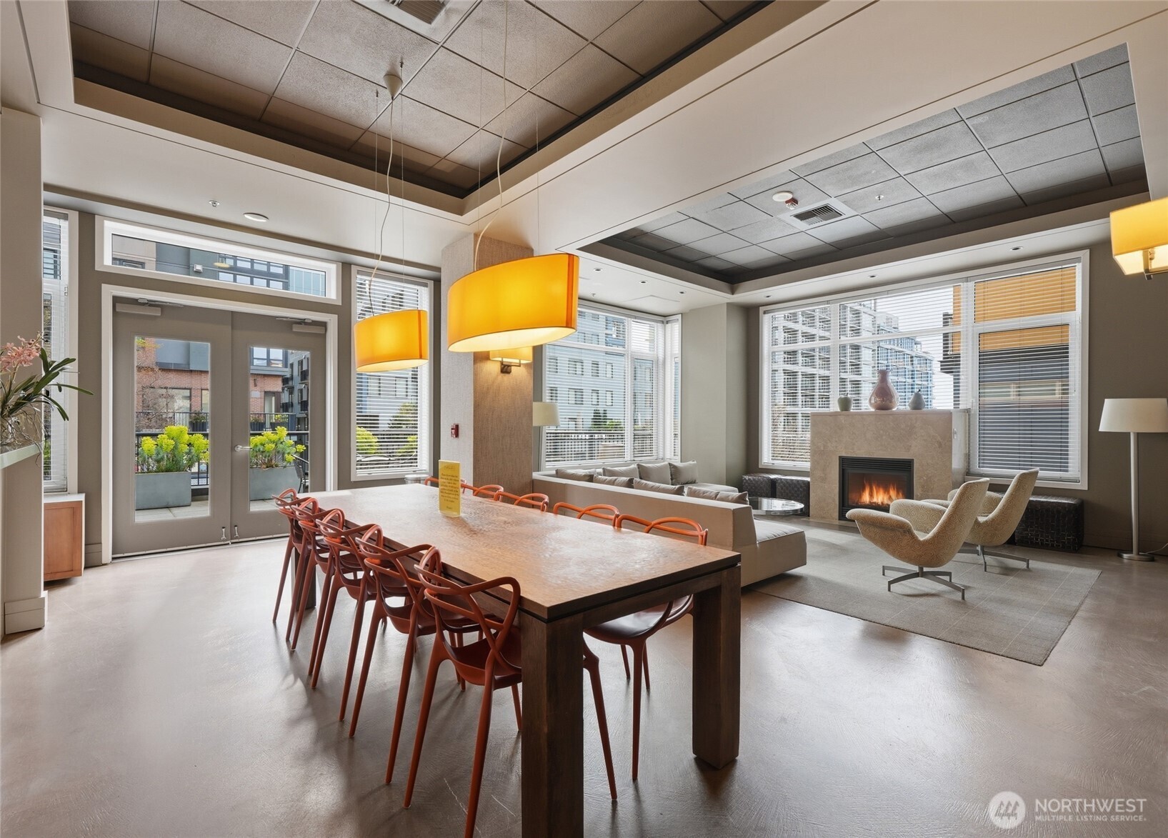 2801 1st Avenue, Unit 504 Seattle, WA 98121 - Photo 21 of 34 a dining room with furniture large windows and a chandelier