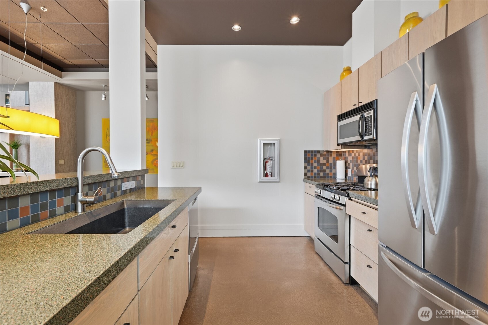 2801 1st Avenue, Unit 504 Seattle, WA 98121 - Photo 22 of 34 a kitchen with stainless steel appliances granite countertop a sink stove and refrigerator