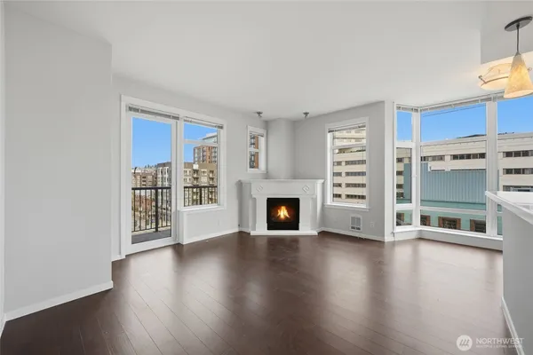 a view of a livingroom with a fireplace wooden floor and window
