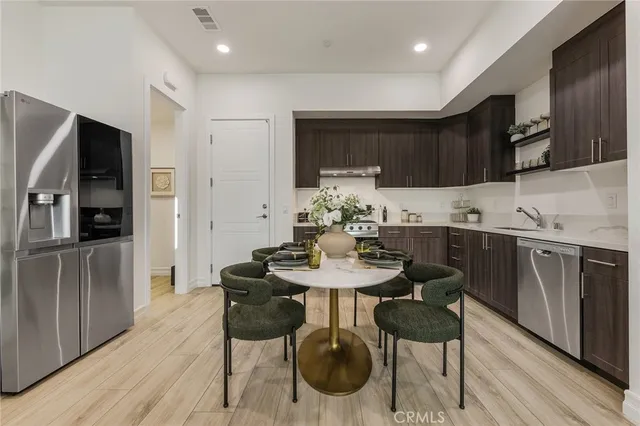 a kitchen with stainless steel appliances kitchen island granite countertop a sink and cabinets