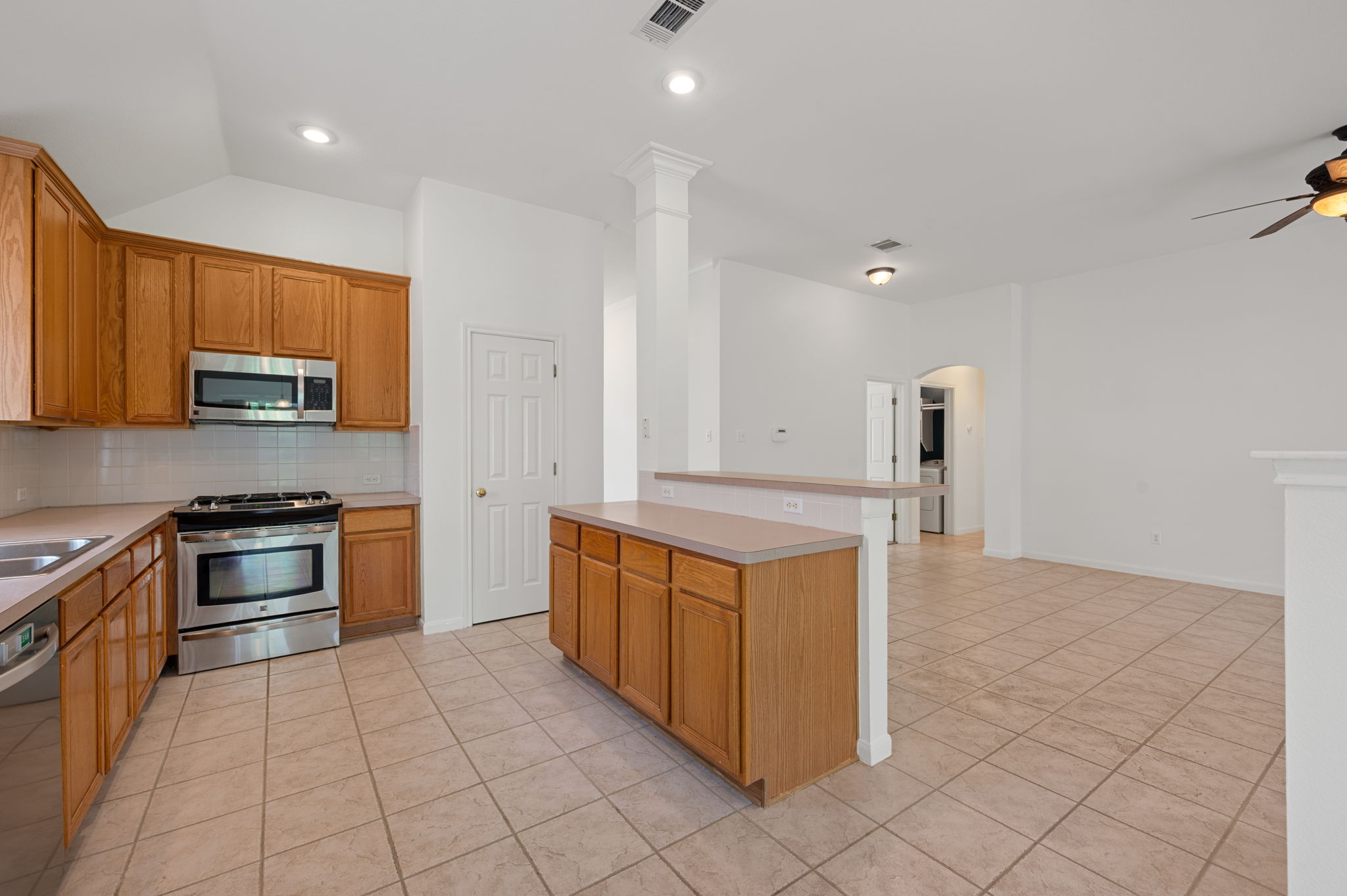9201 La Siesta Bend Austin, TX 78749 - Photo 10 of 37 a kitchen with stainless steel appliances granite countertop a stove a sink and a refrigerator