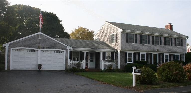 411 Lower County Road Harwich Port, MA 02646 - Photo 1 of 32 a front view of a house with a yard