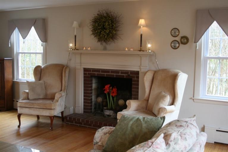 411 Lower County Road Harwich Port, MA 02646 - Photo 12 of 32 a living room with furniture and a fireplace