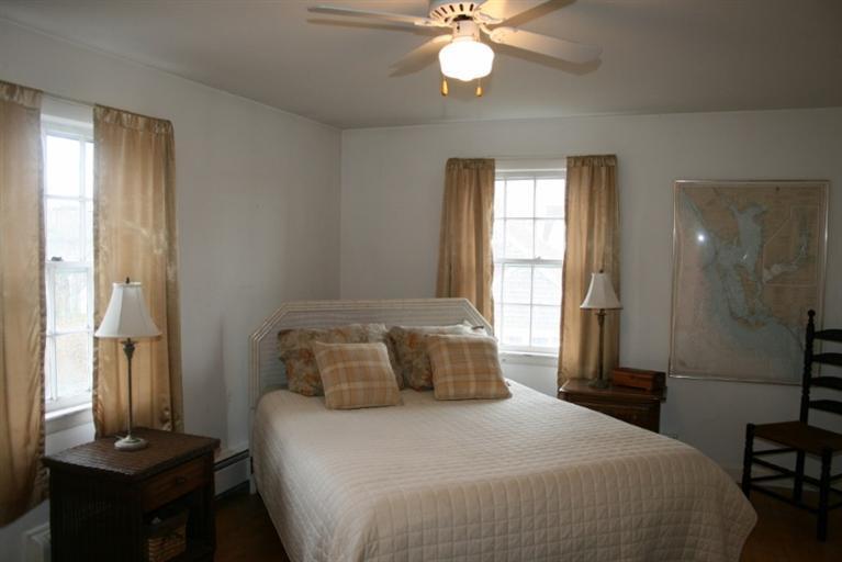 411 Lower County Road Harwich Port, MA 02646 - Photo 17 of 32 a bedroom with a bed and a chandelier