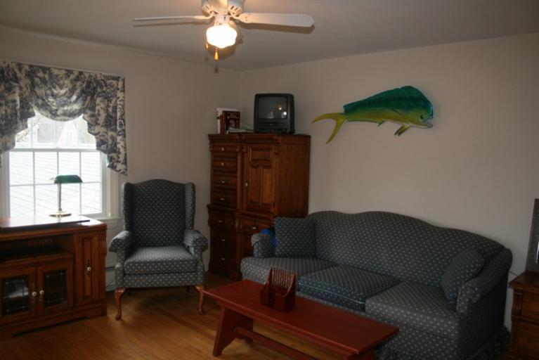 411 Lower County Road Harwich Port, MA 02646 - Photo 19 of 32 a living room with furniture a flat screen tv and a window