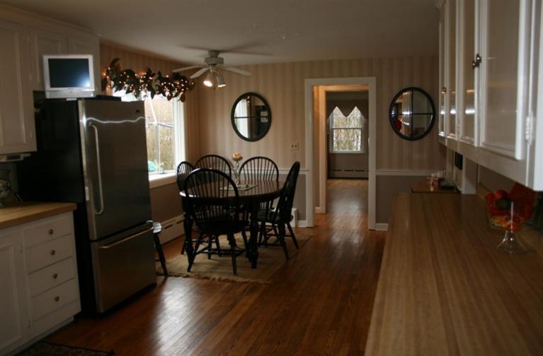 411 Lower County Road Harwich Port, MA 02646 - Photo 2 of 32 a living room with furniture a flat screen tv and wooden floor