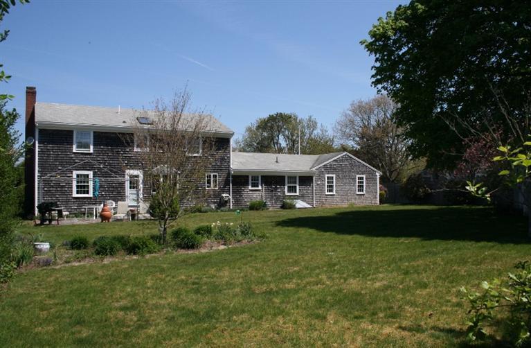 411 Lower County Road Harwich Port, MA 02646 - Photo 29 of 32 a front view of a house with a garden
