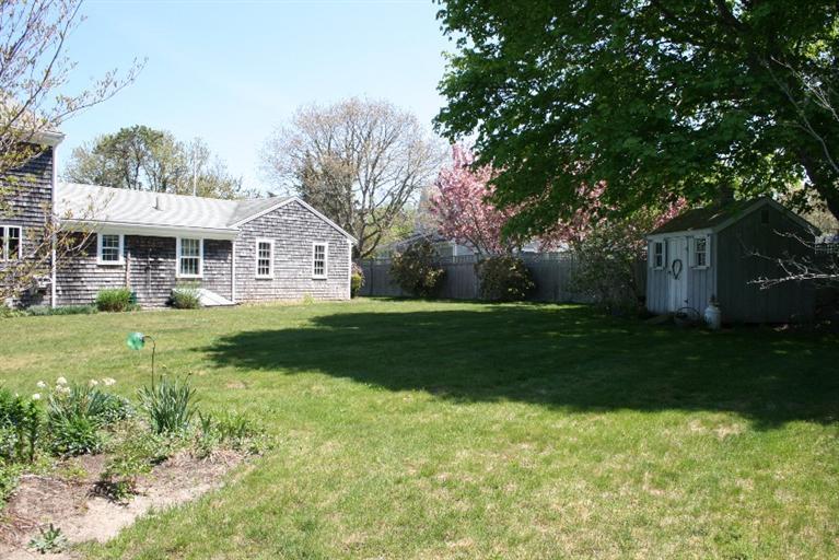 411 Lower County Road Harwich Port, MA 02646 - Photo 30 of 32 a front view of a house with garden