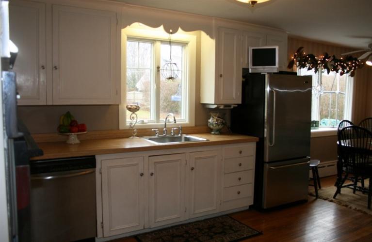 411 Lower County Road Harwich Port, MA 02646 - Photo 3 of 32 a kitchen with stainless steel appliances granite countertop a refrigerator and a sink