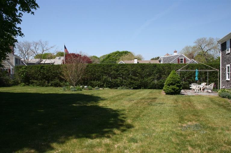 411 Lower County Road Harwich Port, MA 02646 - Photo 31 of 32 a backyard of a house with lots of green space