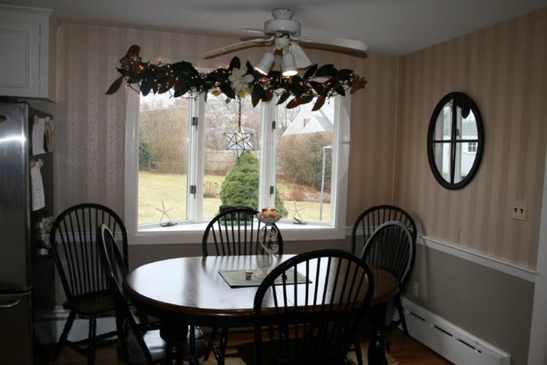 411 Lower County Road Harwich Port, MA 02646 - Photo 5 of 32 a view of a dining room with furniture a chandelier and wooden floor