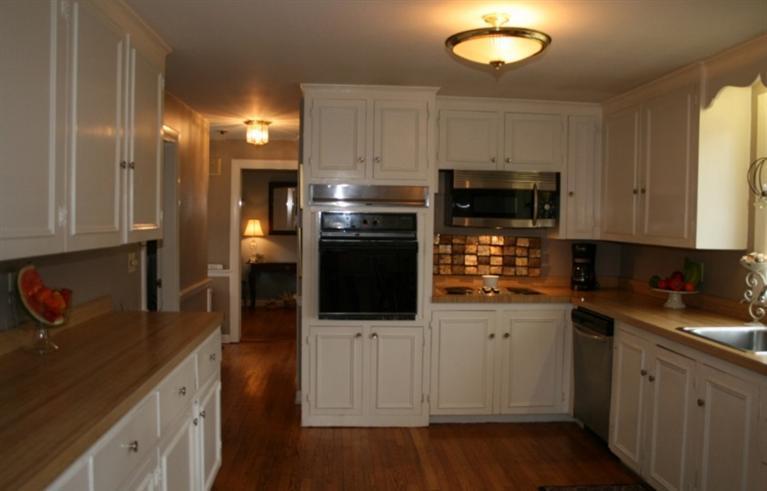 411 Lower County Road Harwich Port, MA 02646 - Photo 6 of 32 a kitchen with a sink stainless steel appliances and cabinets