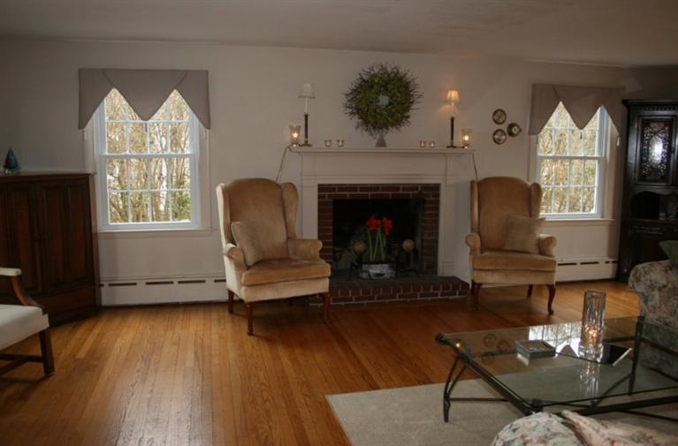 411 Lower County Road Harwich Port, MA 02646 - Photo 7 of 32 a living room with furniture and a fireplace