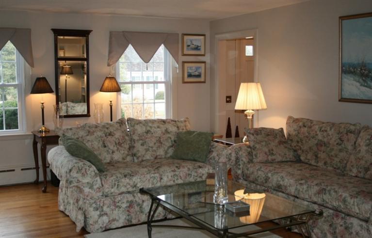 411 Lower County Road Harwich Port, MA 02646 - Photo 9 of 32 a living room with furniture a lamp and a large window