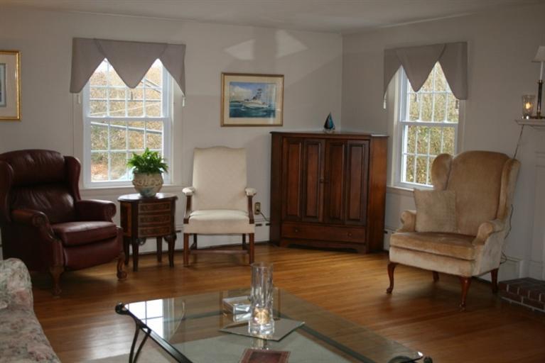 411 Lower County Road Harwich Port, MA 02646 - Photo 10 of 32 a living room with furniture a window and a chandelier