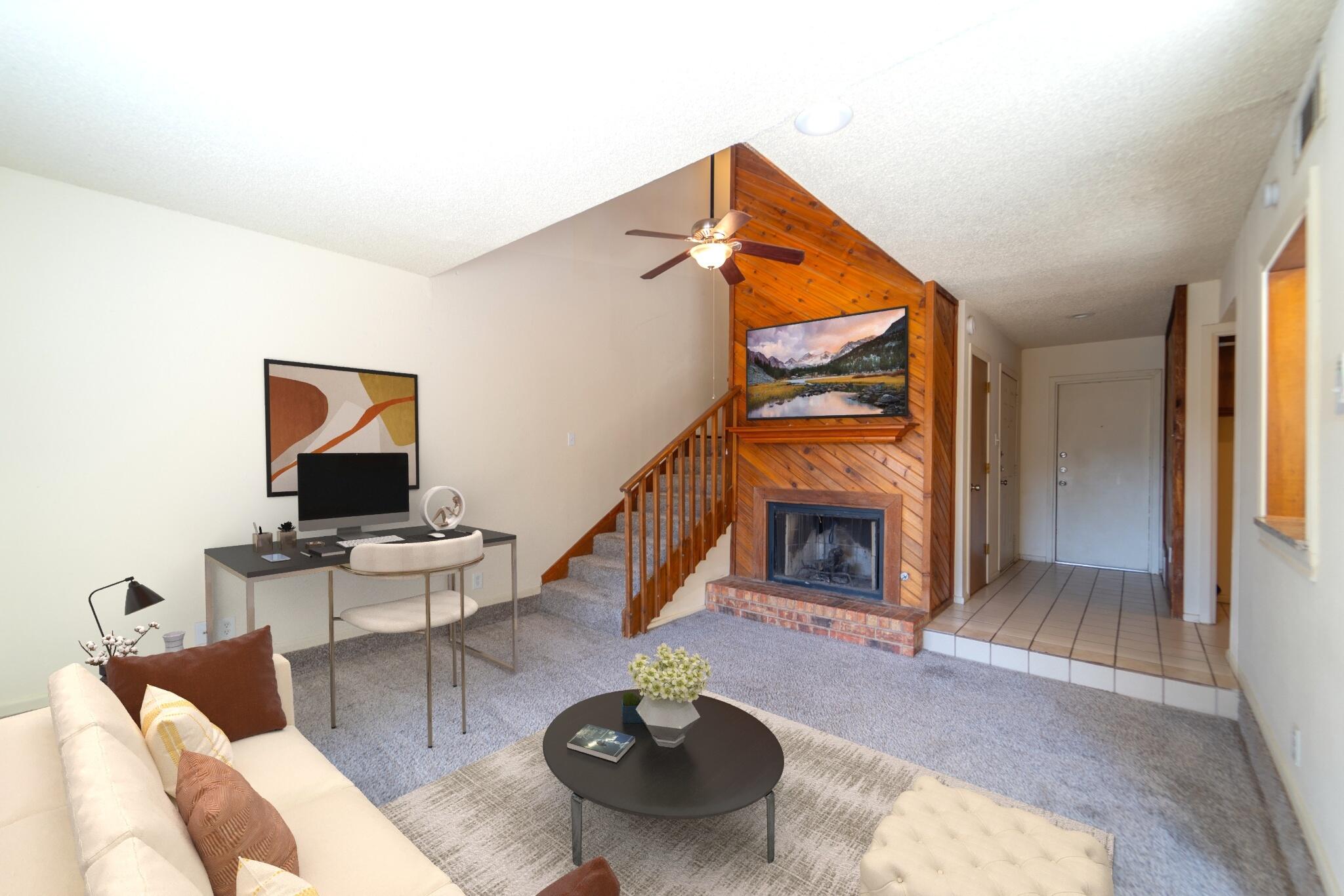 a living room with furniture a fireplace and a flat screen tv