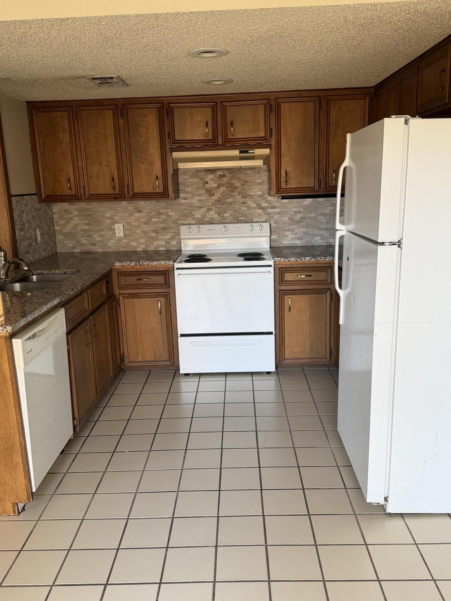 7203 Memphis Avenue, Unit B Lubbock, TX 79423 - Photo 11 of 13 a kitchen with a cabinets and steel appliances