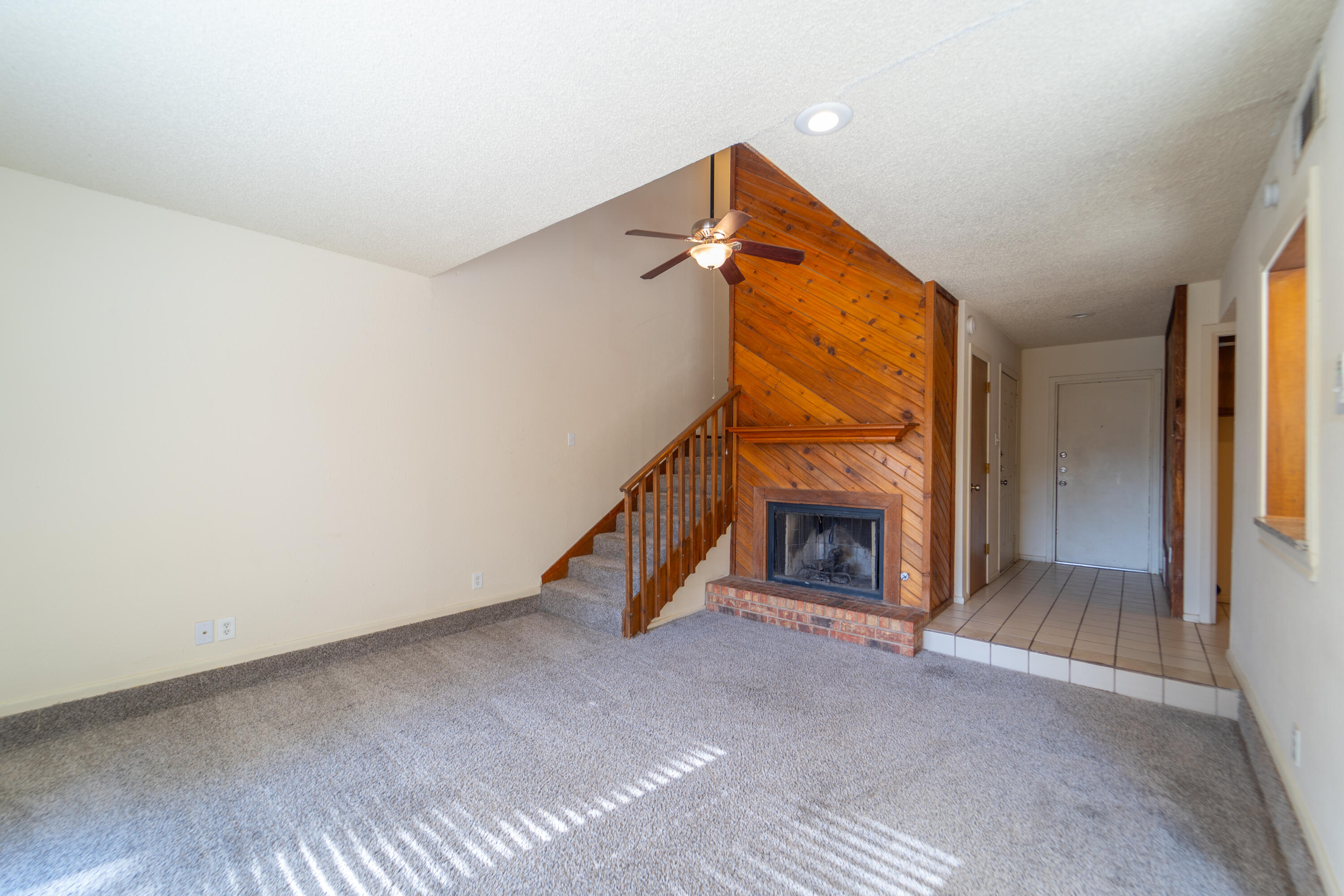 7203 Memphis Avenue, Unit B Lubbock, TX 79423 - Photo 2 of 13 a view of an empty room with fireplace and a window