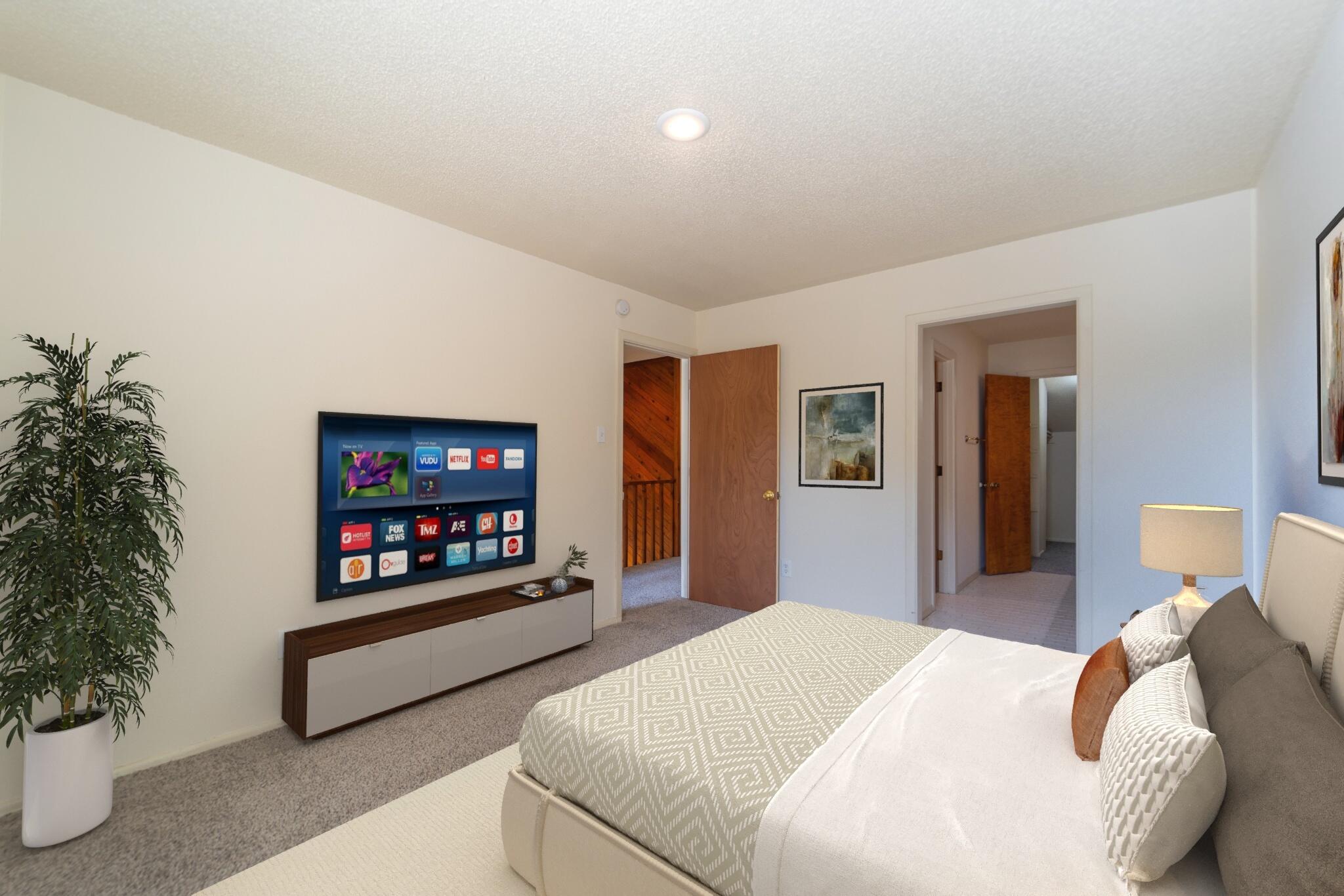 7203 Memphis Avenue, Unit B Lubbock, TX 79423 - Photo 7 of 13 a bedroom with furniture and a potted plant