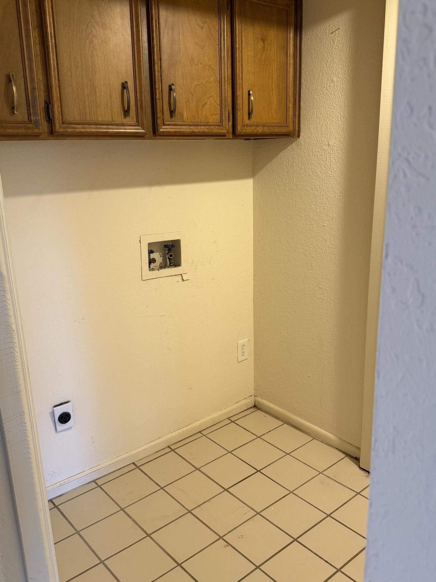 7203 Memphis Avenue, Unit B Lubbock, TX 79423 - Photo 9 of 13 a view of a utility room with wooden floor