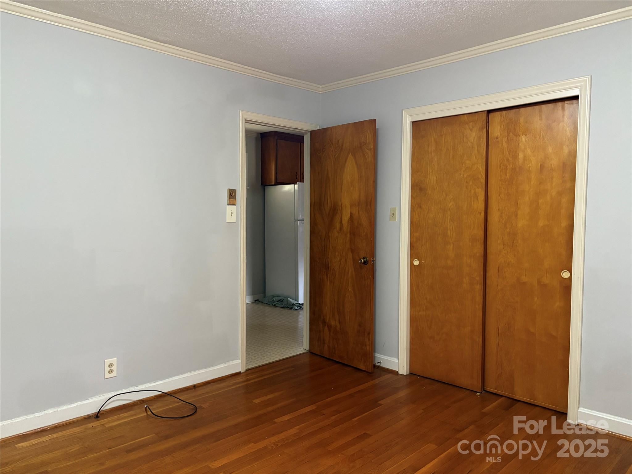 107 Ferstl Avenue Belmont, NC 28012 - Photo 14 of 15 an empty room with wooden floor and a window