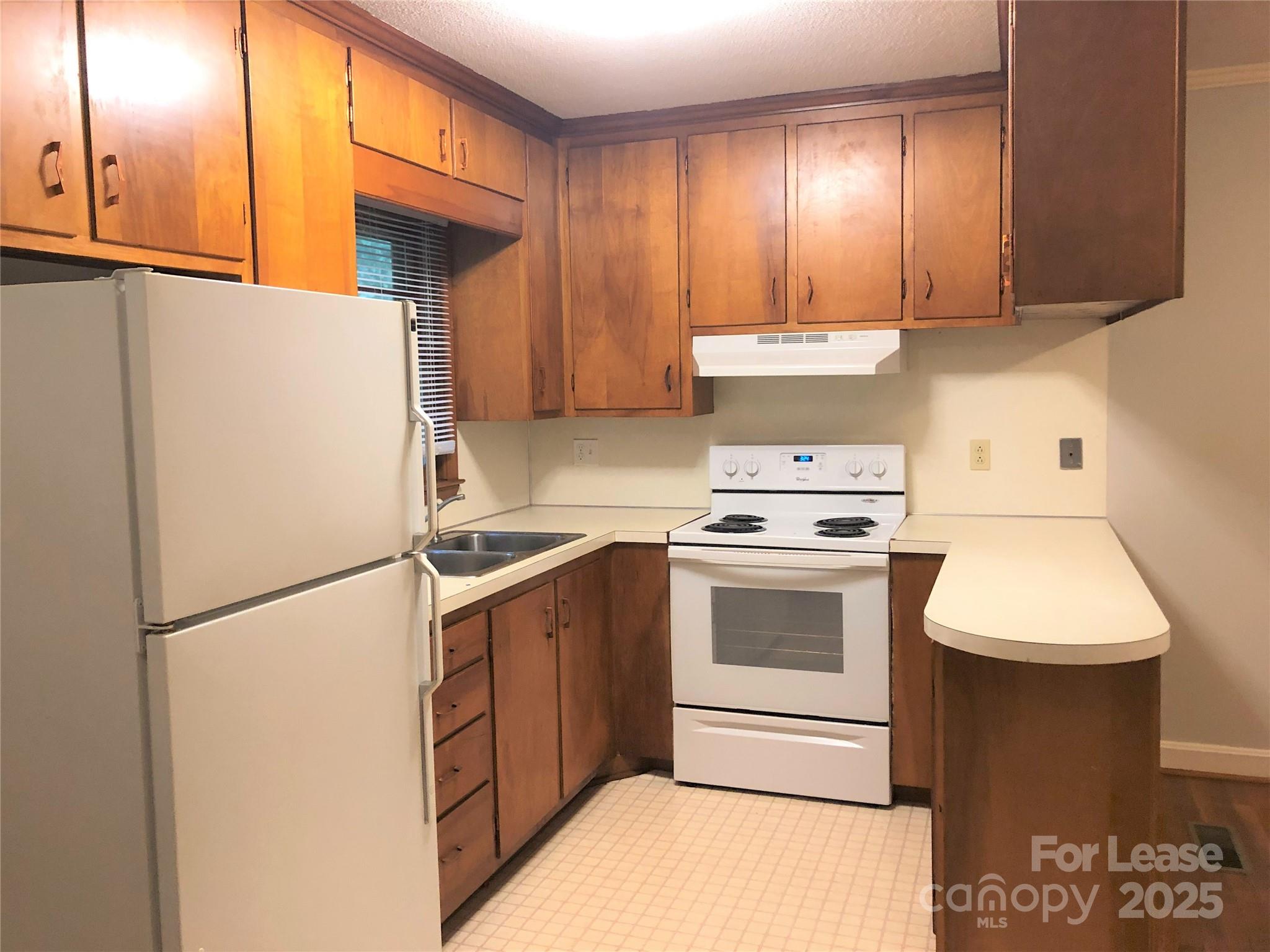 107 Ferstl Avenue Belmont, NC 28012 - Photo 6 of 15 a kitchen with a stove cabinets and a refrigerator