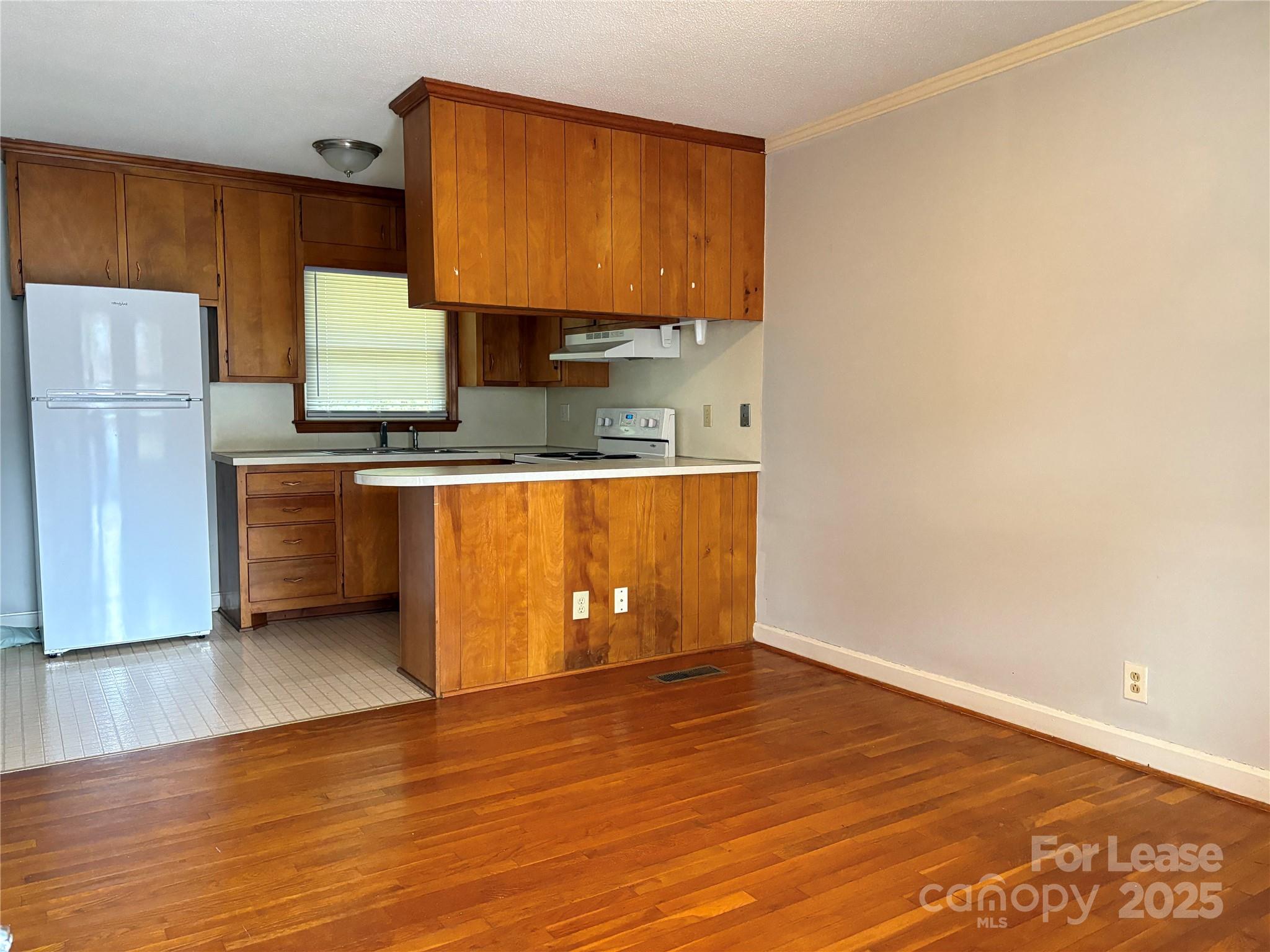 107 Ferstl Avenue Belmont, NC 28012 - Photo 7 of 15 a kitchen with stainless steel appliances granite countertop a sink cabinets and wooden floor