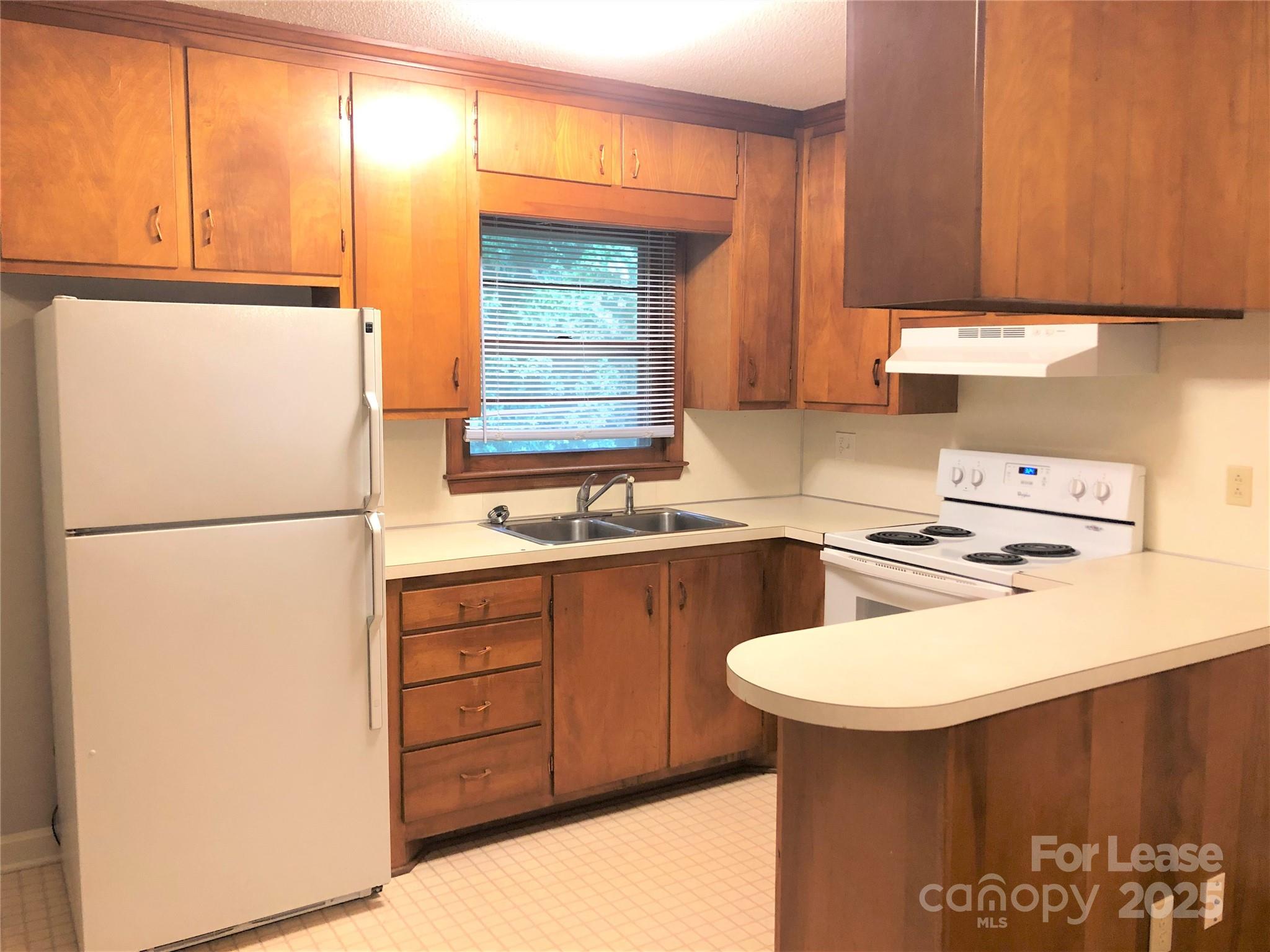 107 Ferstl Avenue Belmont, NC 28012 - Photo 8 of 15 a kitchen with a refrigerator a stove a sink and a cabinets
