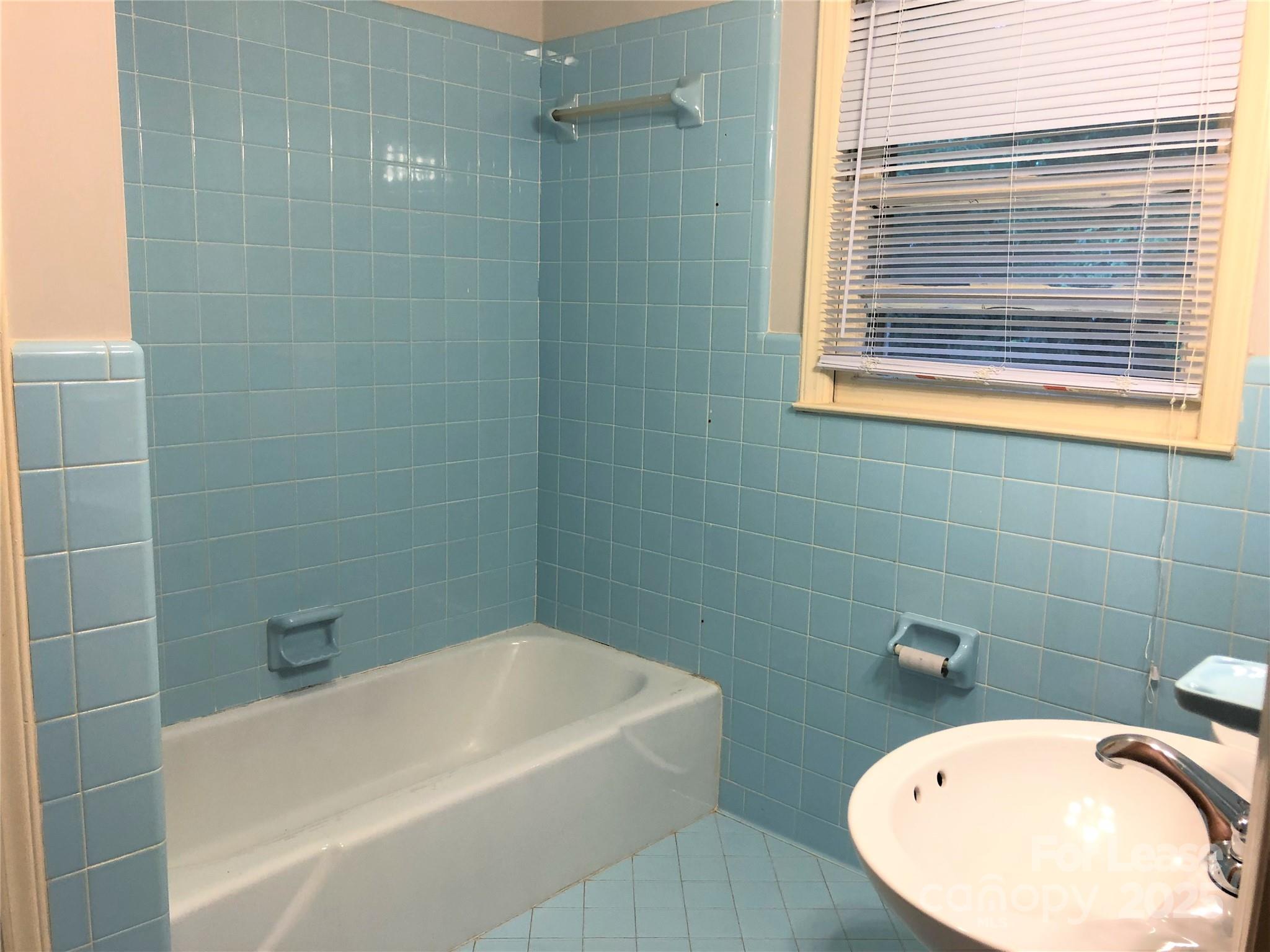 107 Ferstl Avenue Belmont, NC 28012 - Photo 10 of 15 a bathroom with a white bath tub a shower and a sink