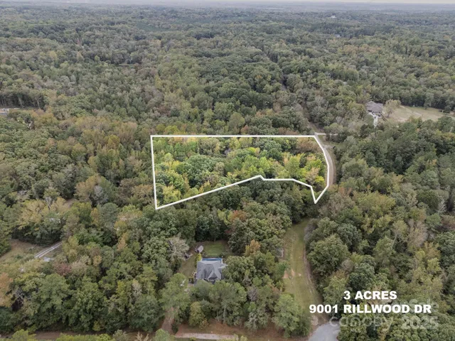 an aerial view of a houses with yard