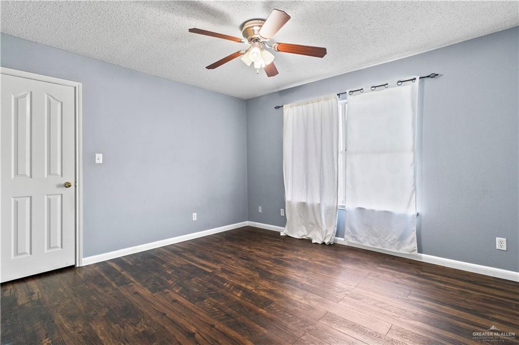 903 North 35 Street Hidalgo, TX 78557 - Photo 4 of 11 wooden floor in an empty room with a window