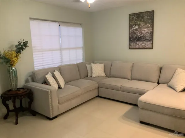 a living room with furniture and a large window
