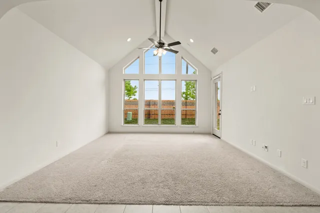 an empty room with windows and outdoor view