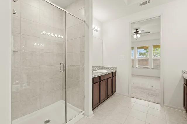 a bathroom with a shower and a sink