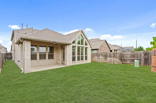 a view of a house with a yard and sitting area