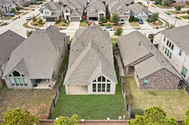 an aerial view of a house with outdoor space and lake view